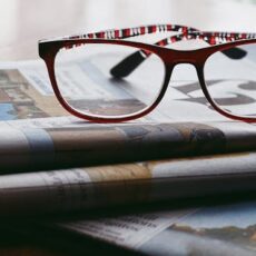 Glasses on newspapers